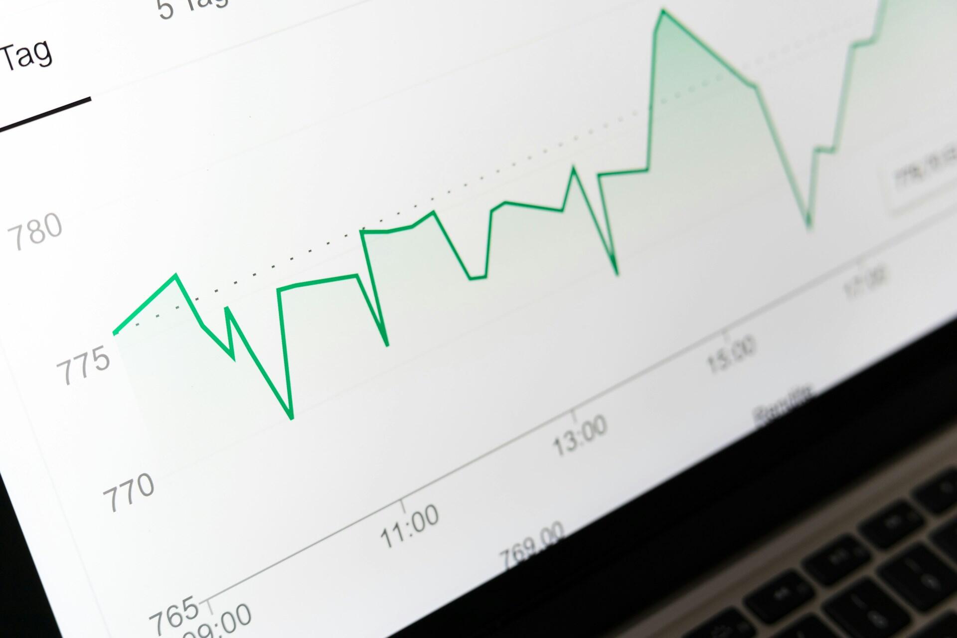 Green line graph displayed on a laptop screen