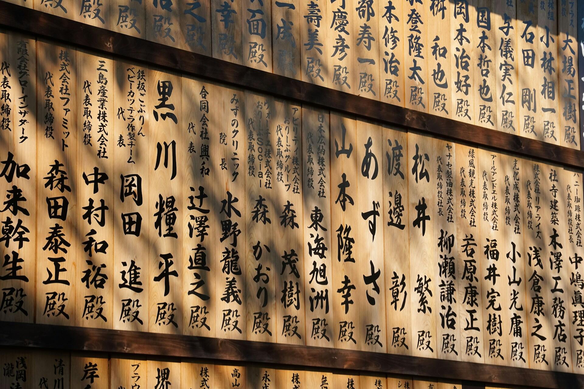 Large panels of sepia-toned paper featuring Japanese calligraphy written in black ink.