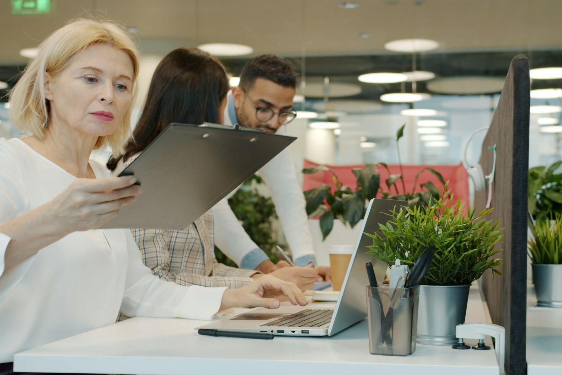 Colleagues working and talking together in a modern office