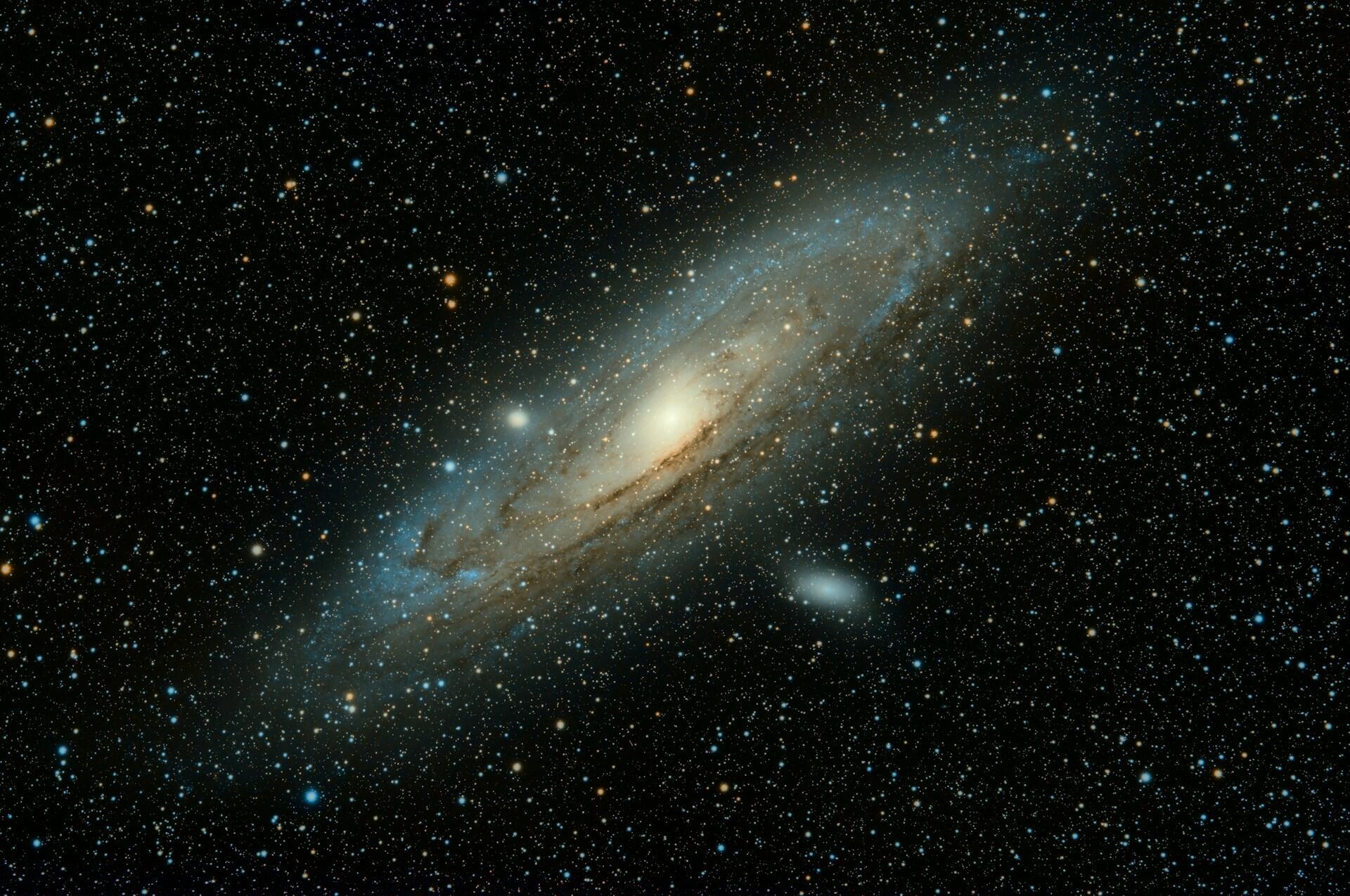 Spiral galaxy with a bright core and blue-white arms, surrounded by a dense field of stars.