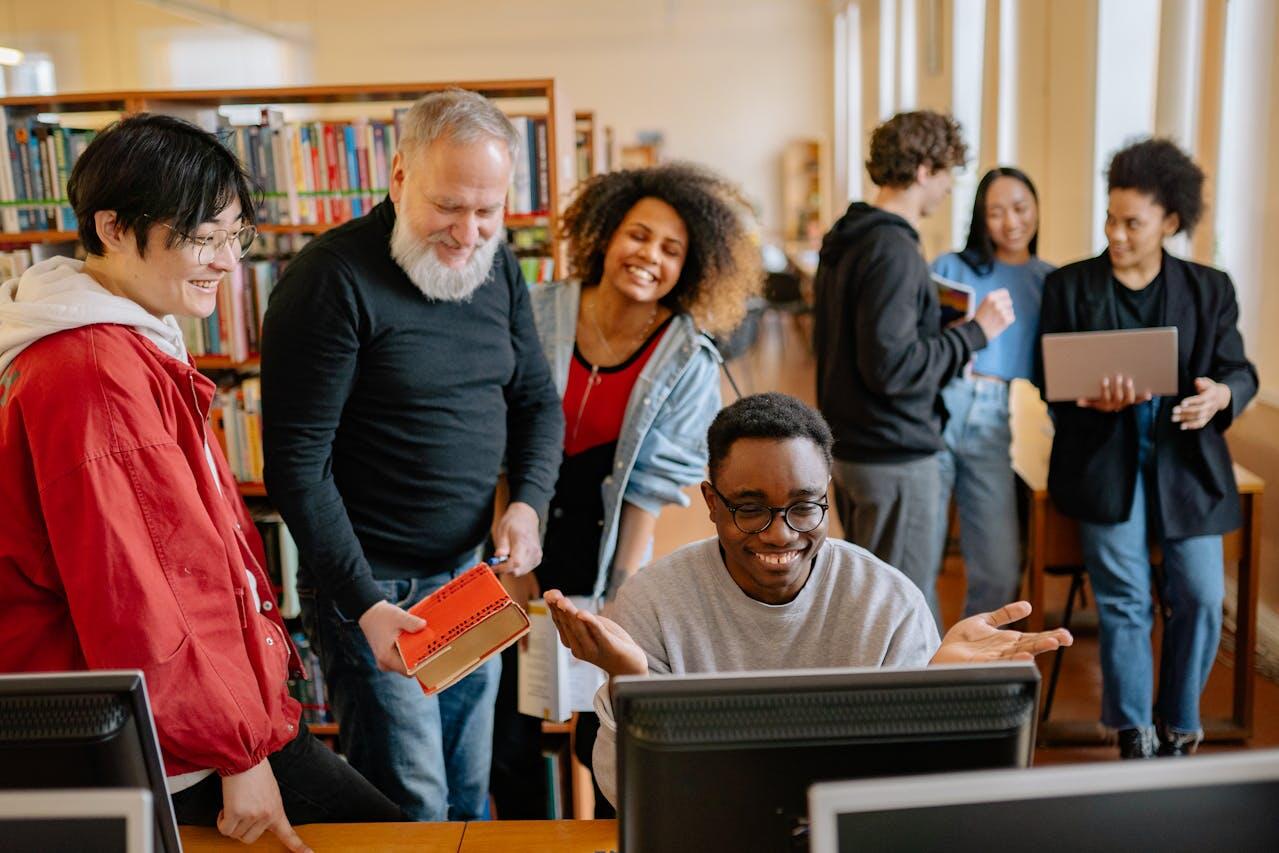 groupe de personnes autour d un ordi a la bibliotheque