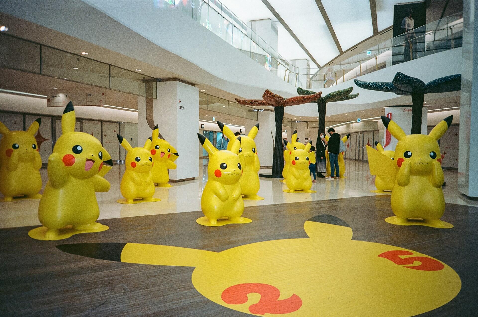 Vários personagens do pikachu em um corredor comercial