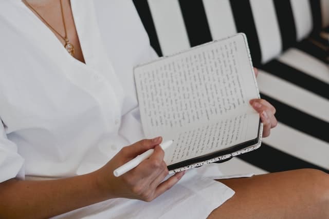 mulher escrevendo em caderno