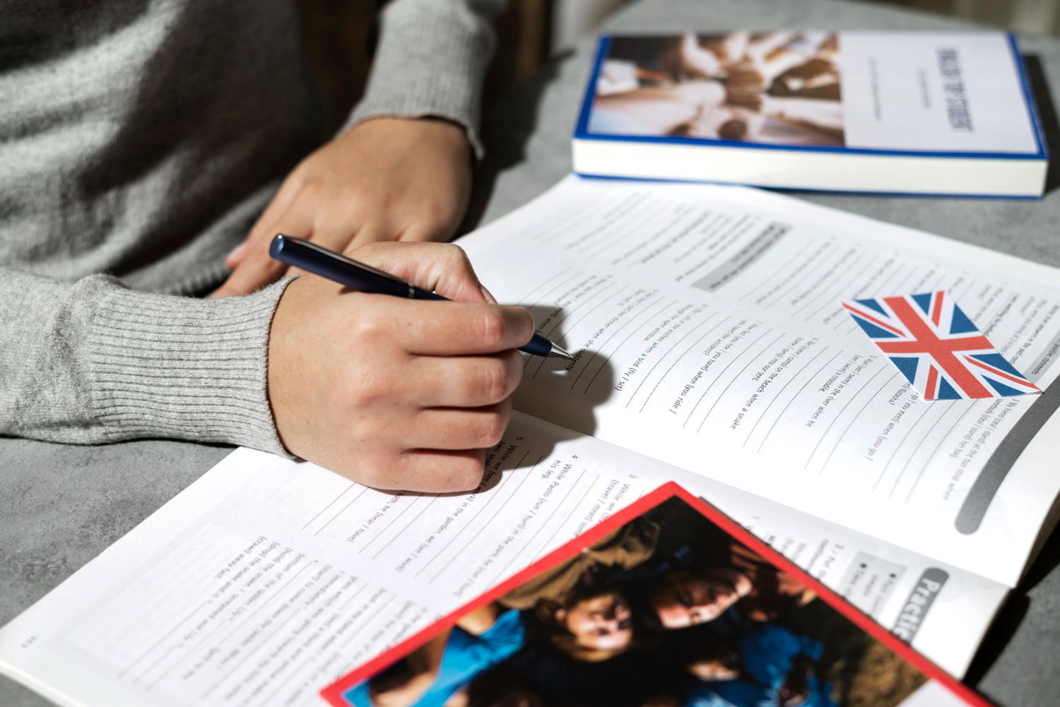 Aluno resolvendo questões de inglês pelo livro.