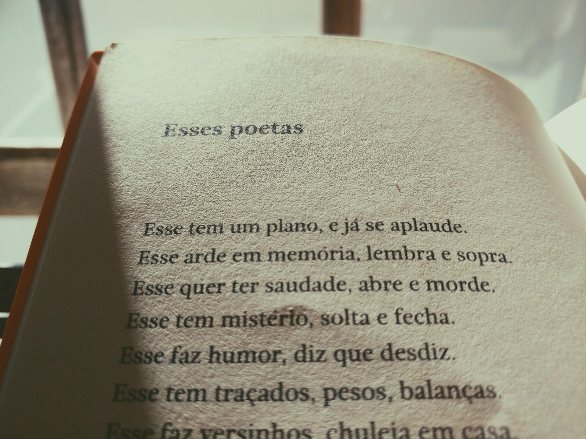 Open book showing a Portuguese poem titled 