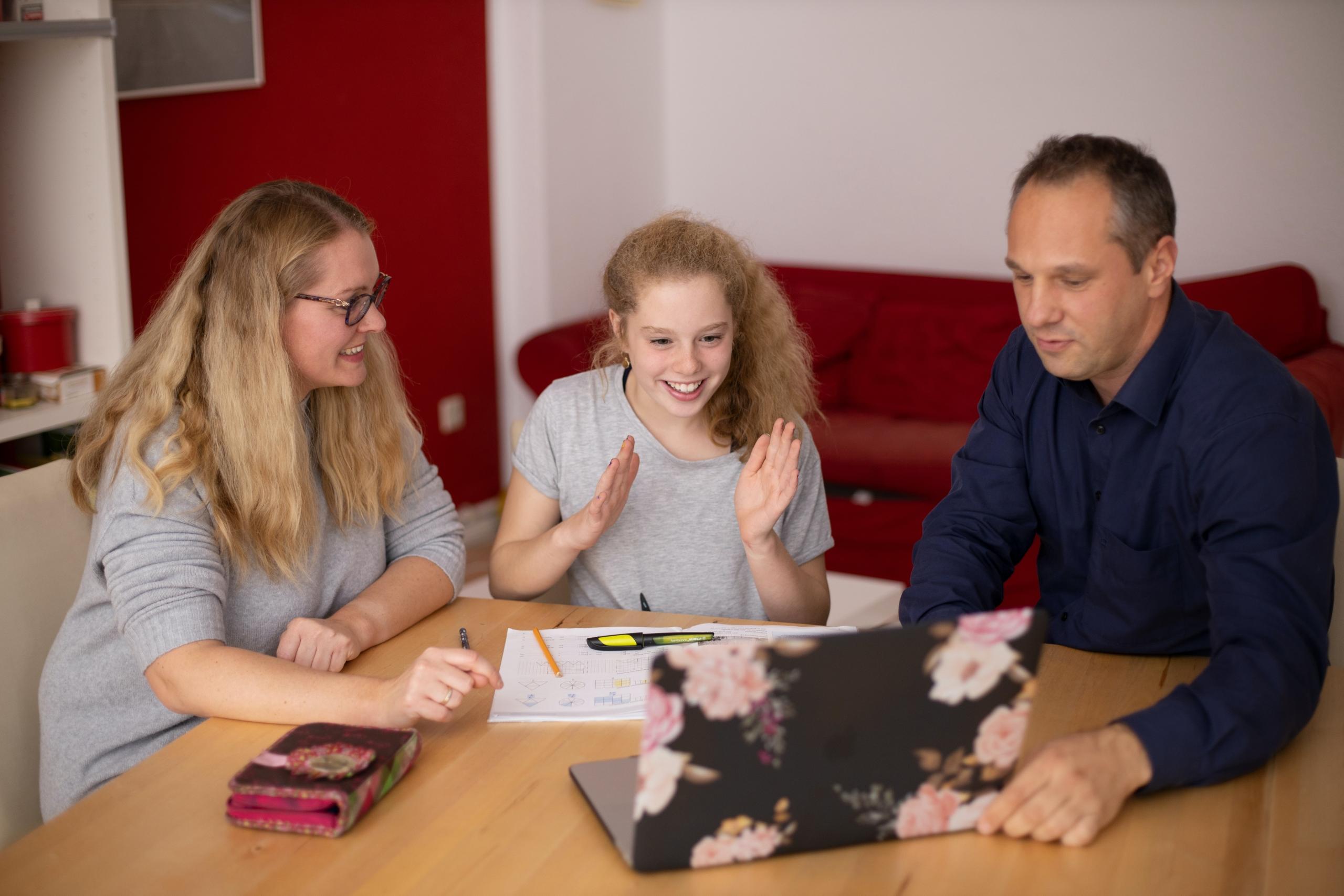parents help a child with school work.