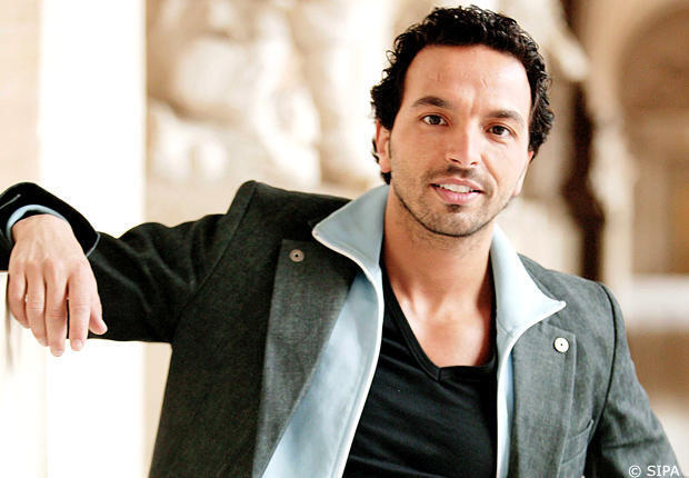 Kamel Ouali posing confidently, celebrated choreographer of musical theatre in France.