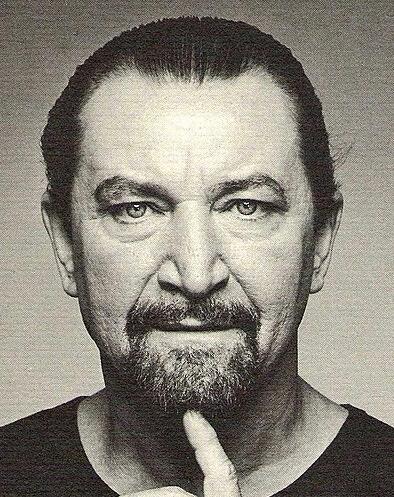 Maurice Béjart in a black-and-white portrait, renowned for revolutionizing modern dance.