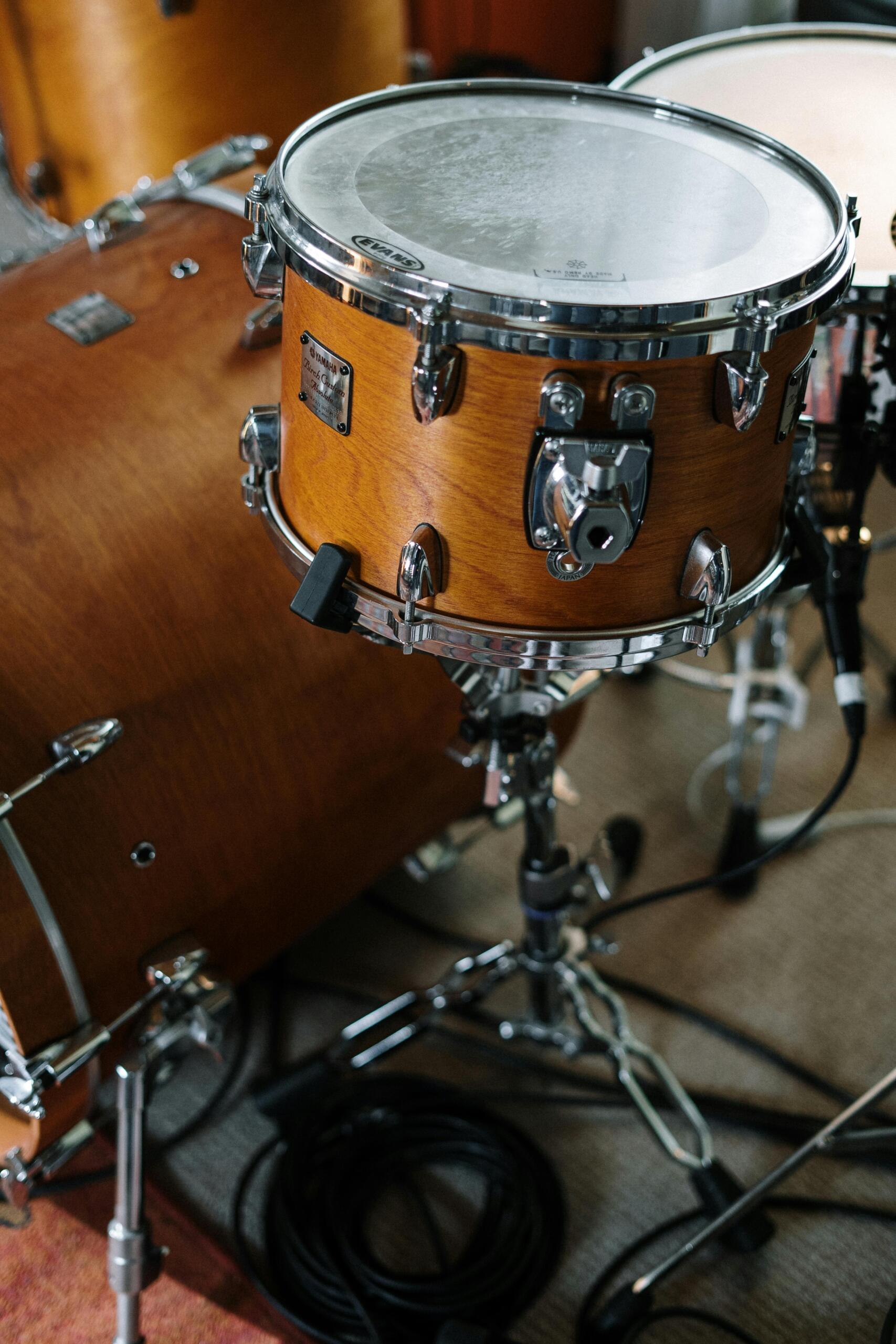 Close-up of brown tom-tom drums highlighting their wooden shells and mounted hardware.
