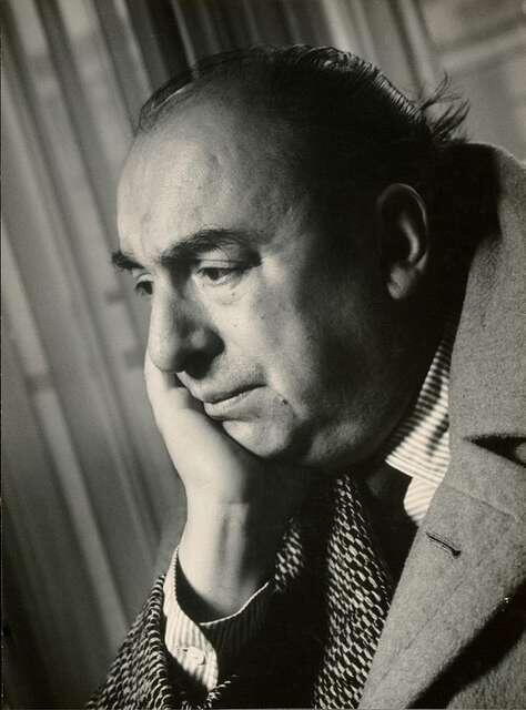 A black-and-white photograph of Pablo Neruda, resting his face on his hand with a contemplative expression.