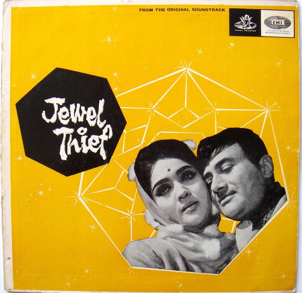 Vintage album cover of the Bollywood film Jewel Thief featuring black-and-white portraits of lead actors Dev Anand and Vyjayanthimala against a bold yellow background with geometric jewel patterns