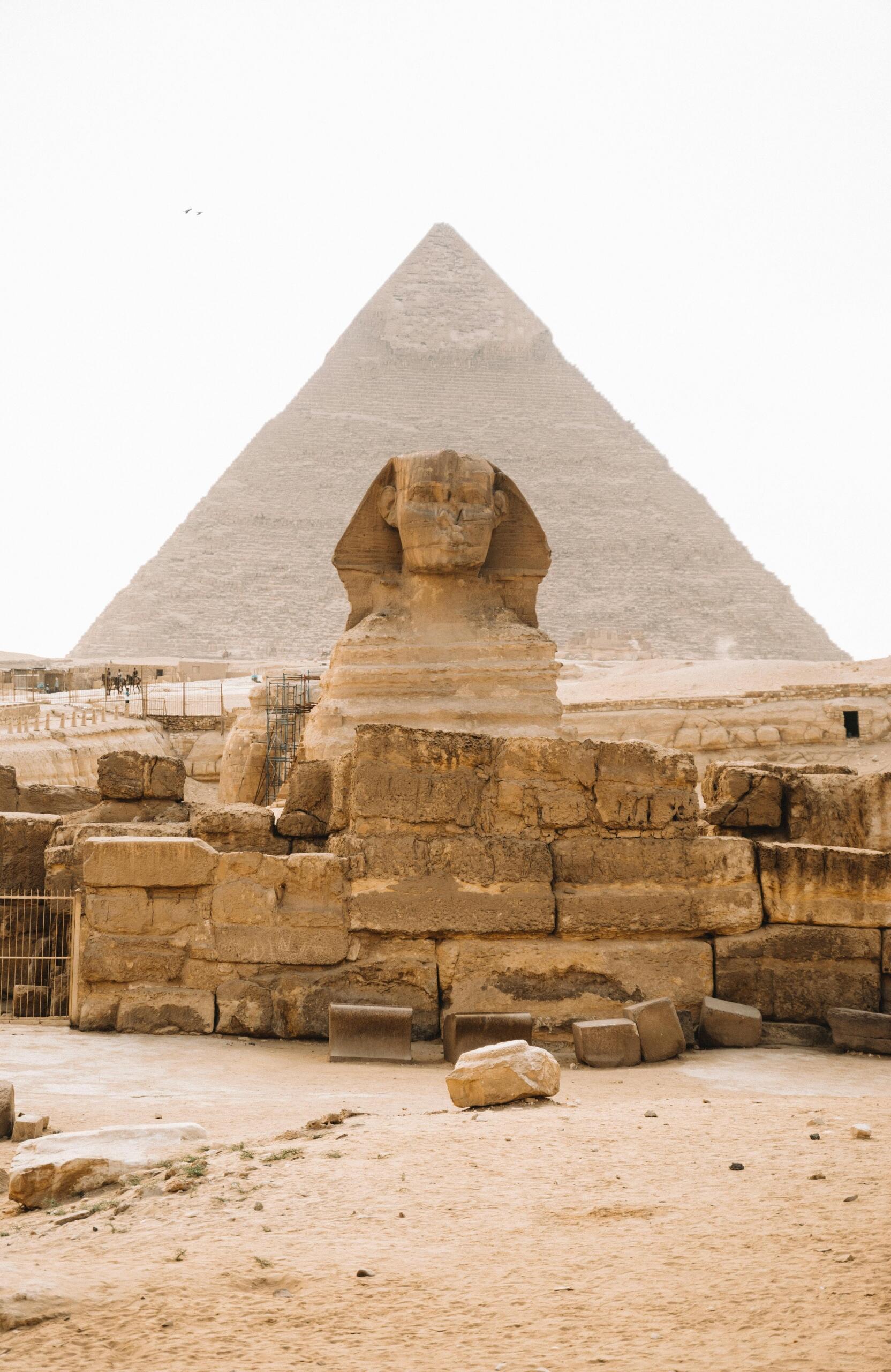 The Great Sphinx in front of a towering pyramid in Egypt, set against a clear sky, showcasing the grandeur of ancient Egyptian architecture and mythology. Source: Alexa Zabache.