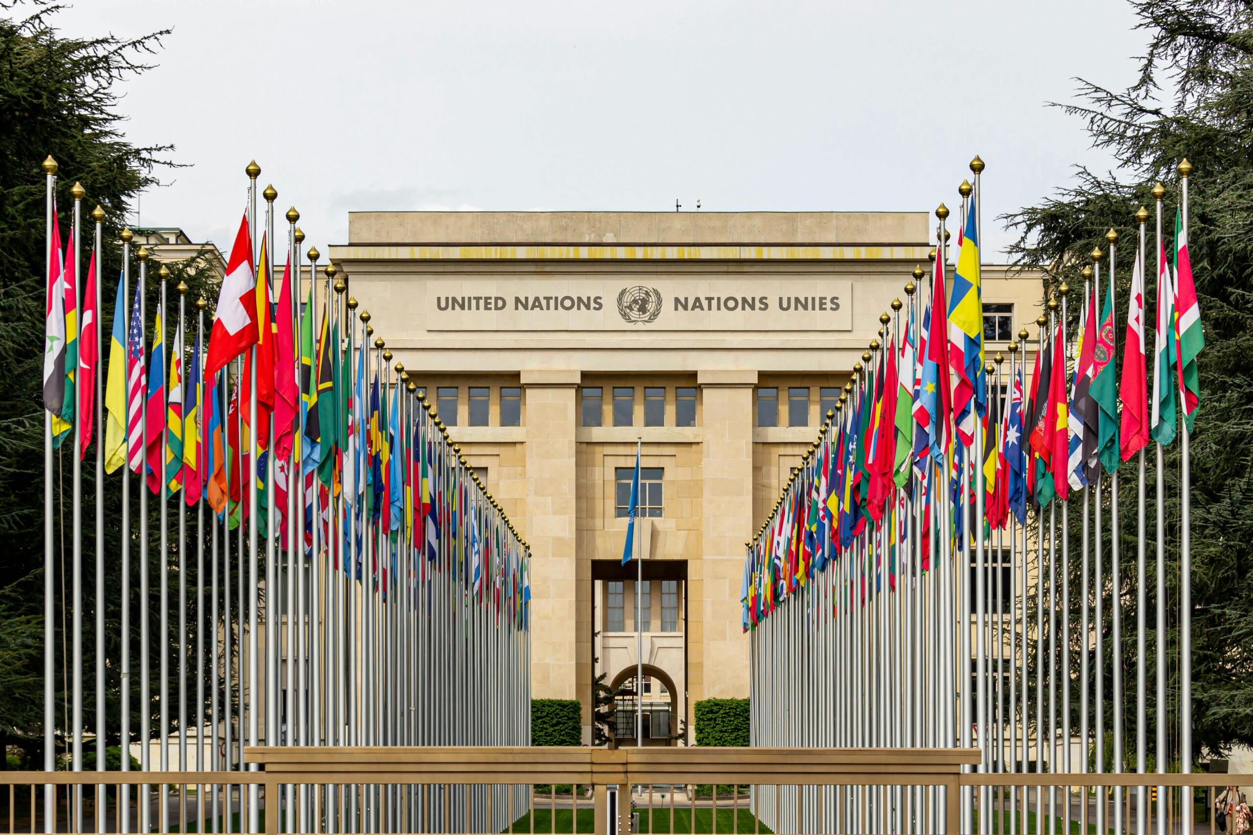 The United Nations building, with the structure’s recognizable row of international flags in the background, representing global unity and diplomacy.