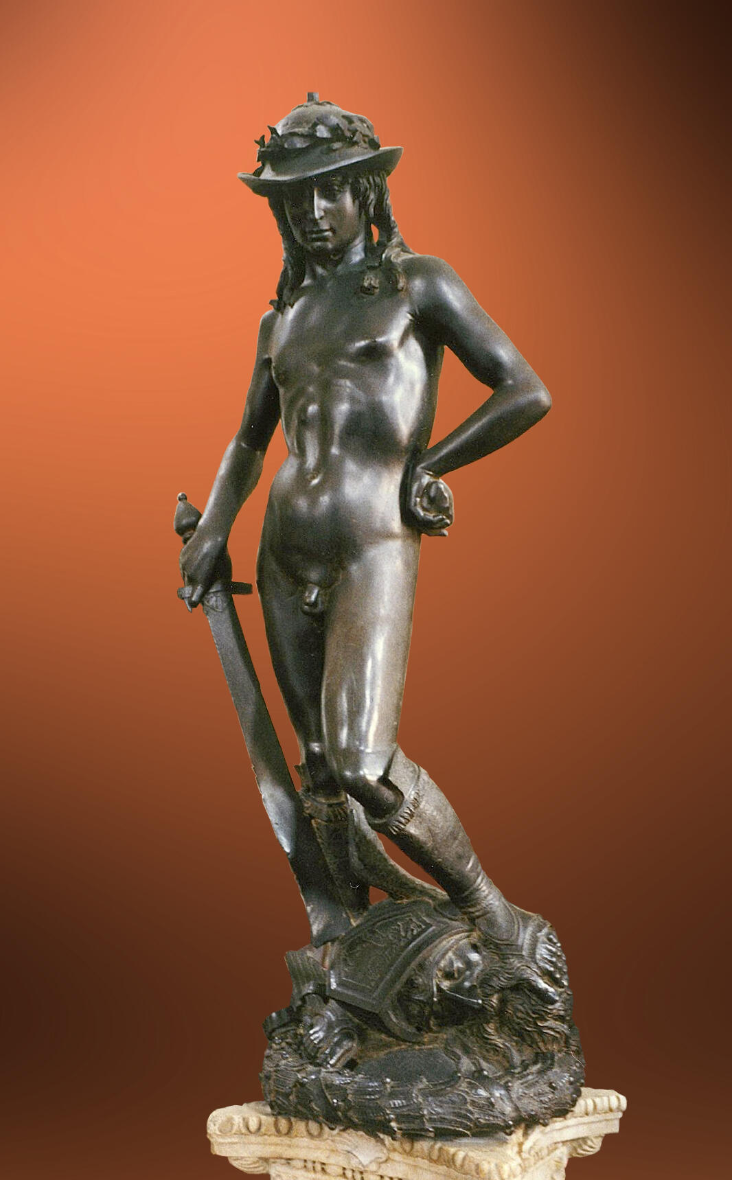 Bronze statue of David by Donatello standing triumphantly over Goliath's severed head.