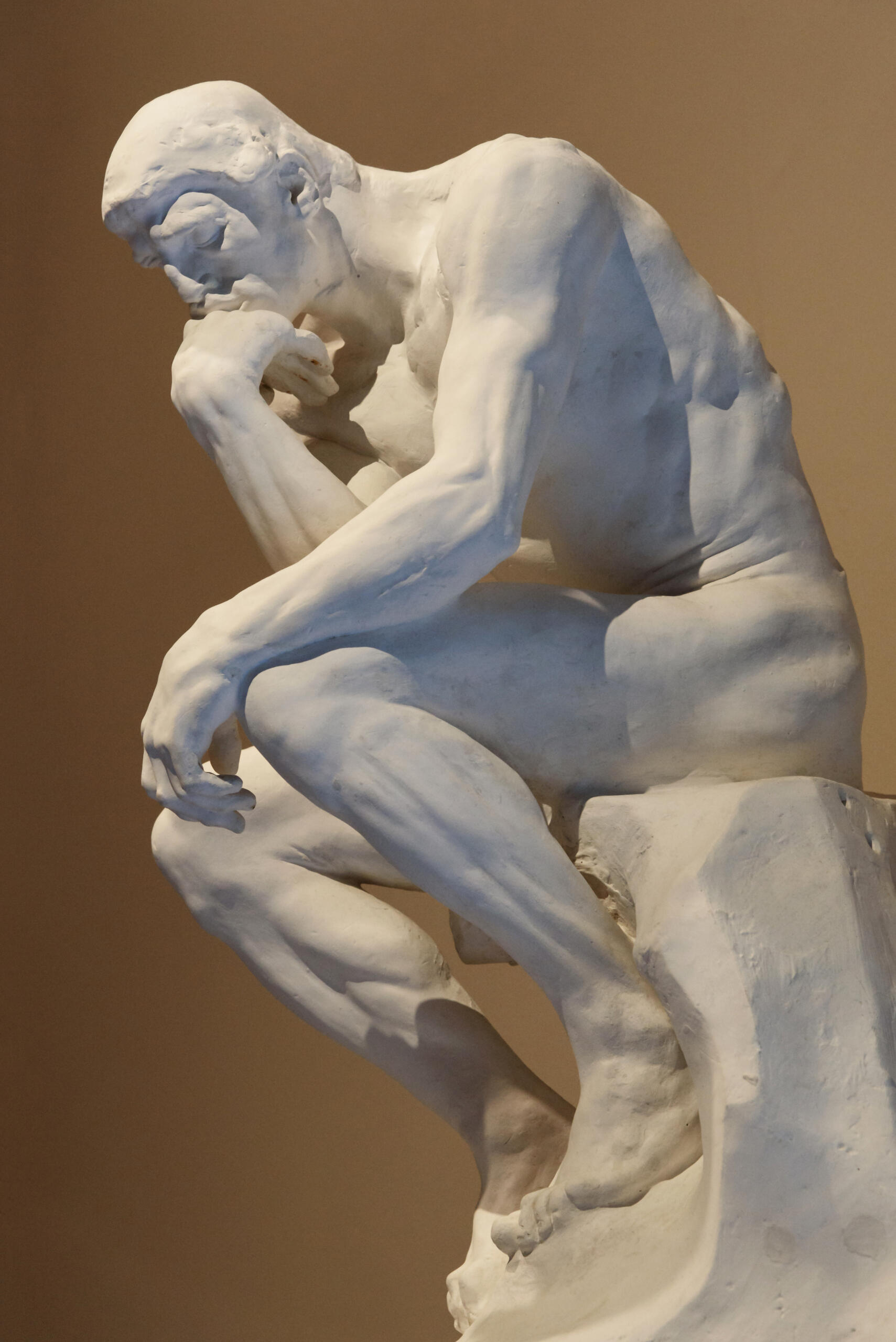Auguste Rodin's The Thinker, depicting a seated man in deep contemplation