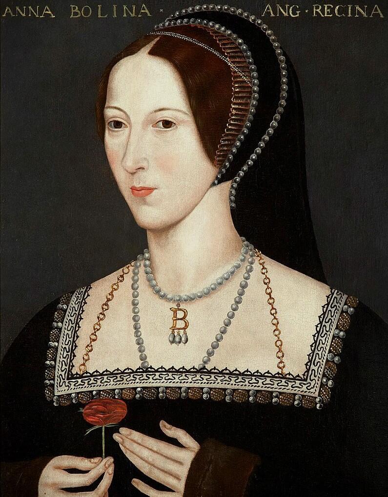 A portrait of a woman in a black dress with intricate embroidery, wearing layered pearls and a pendant, holding a red flower.