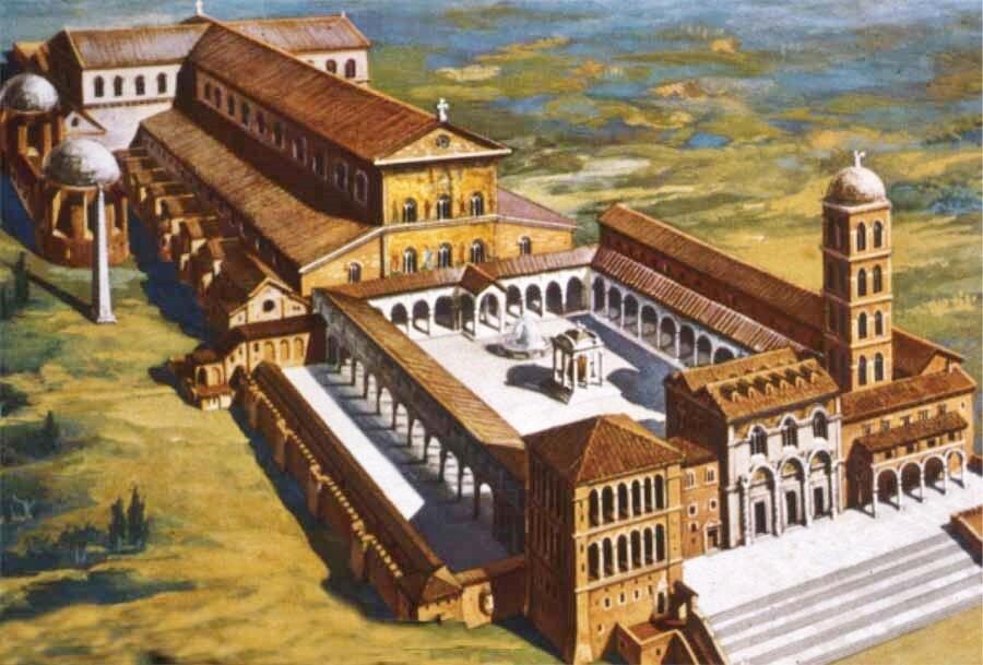 Aerial view of a grand historical complex featuring a large courtyard, multiple buildings, domes, and a prominent bell tower.