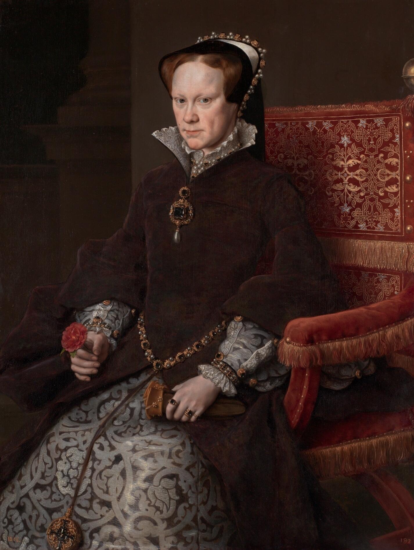 A richly dressed figure in a velvet gown with intricate patterns sits elegantly in a red chair, holding a flower and a small object.