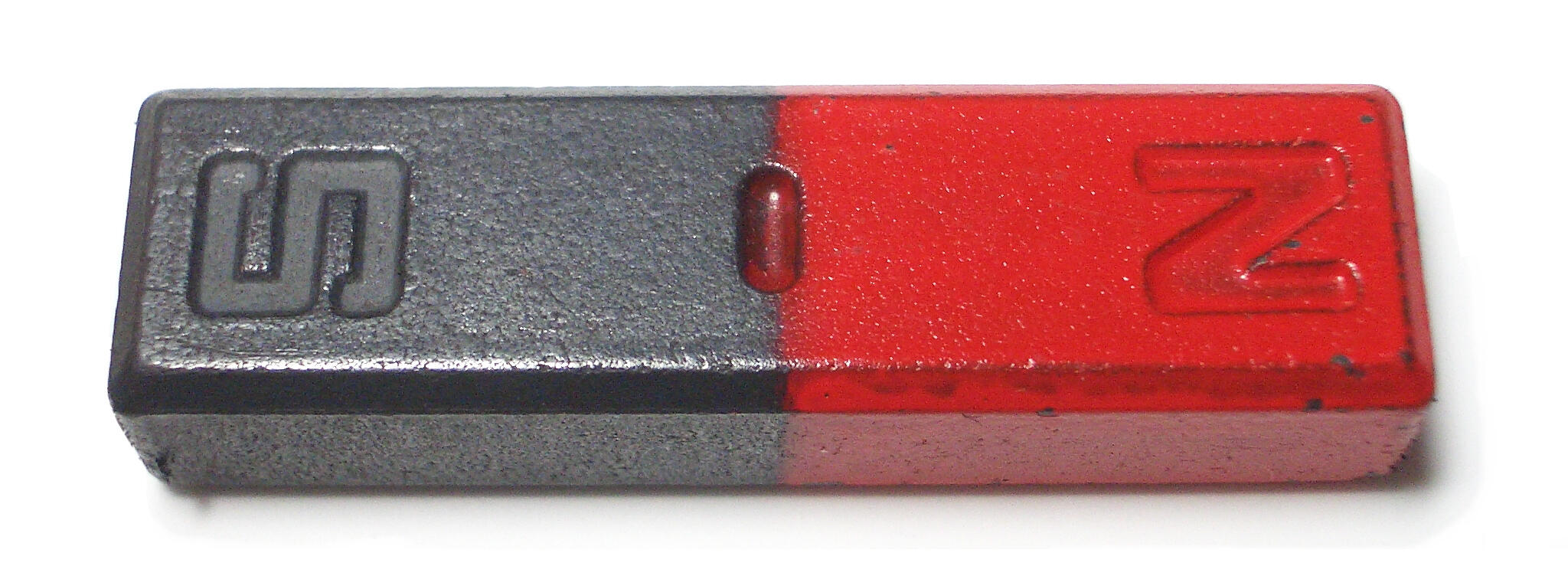 A red and metallic bar magnet showing clearly labelled north and south poles.