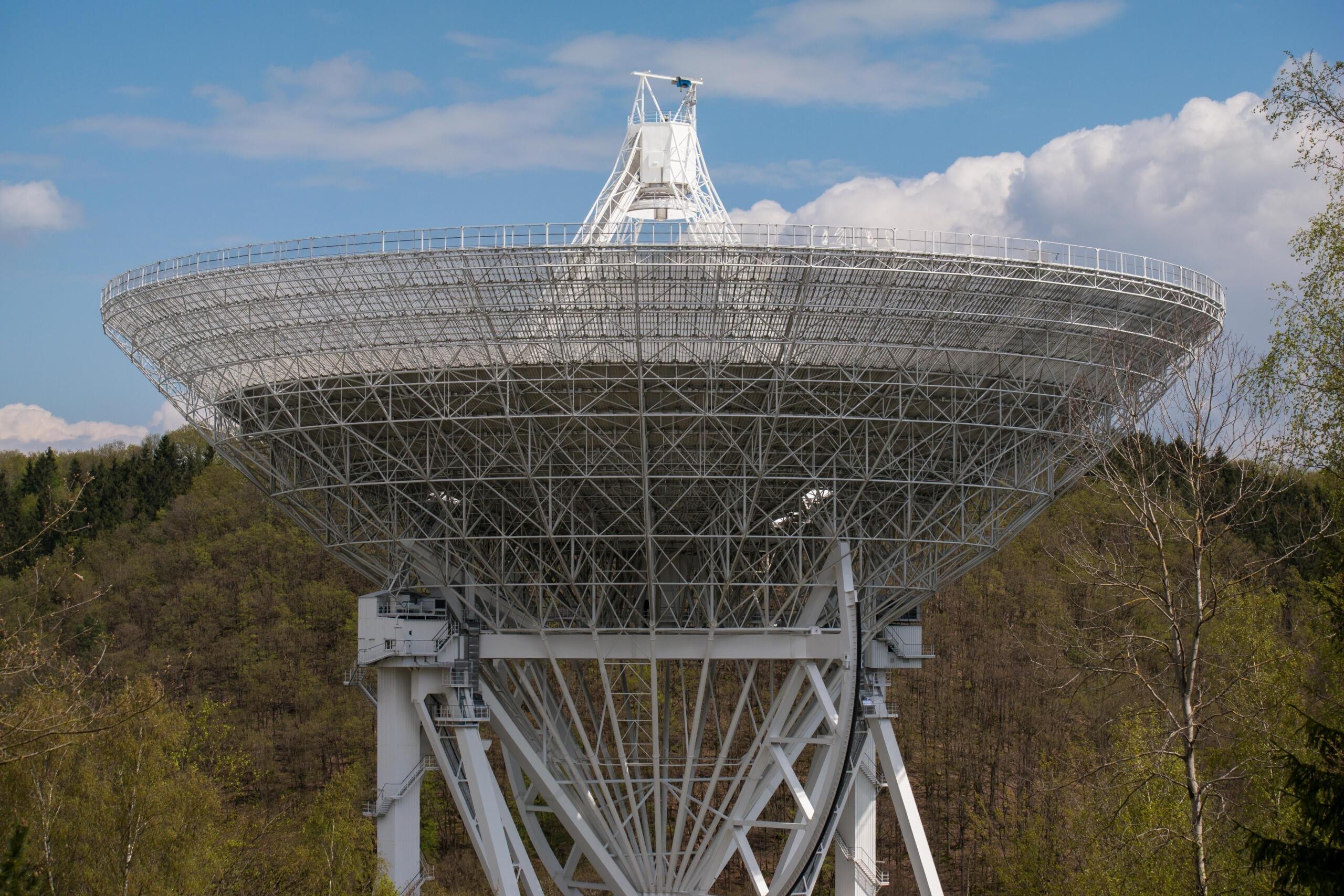Large satellite with extended solar panels and communication equipment.