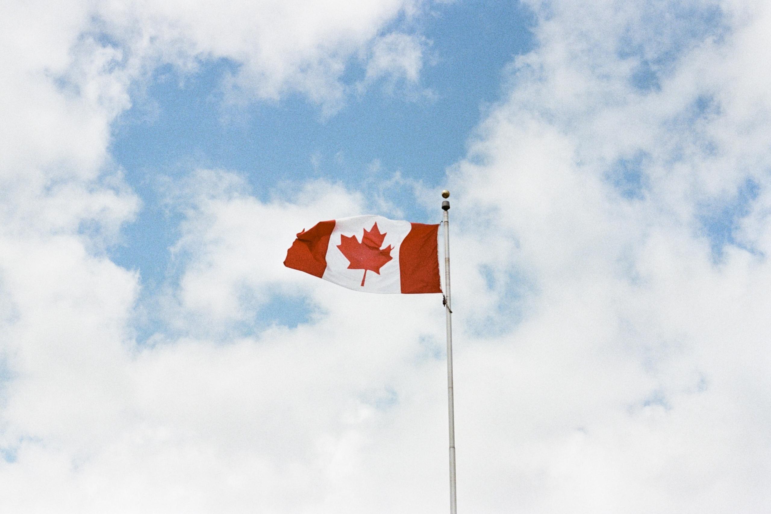 A Canada flag blows in the wind.