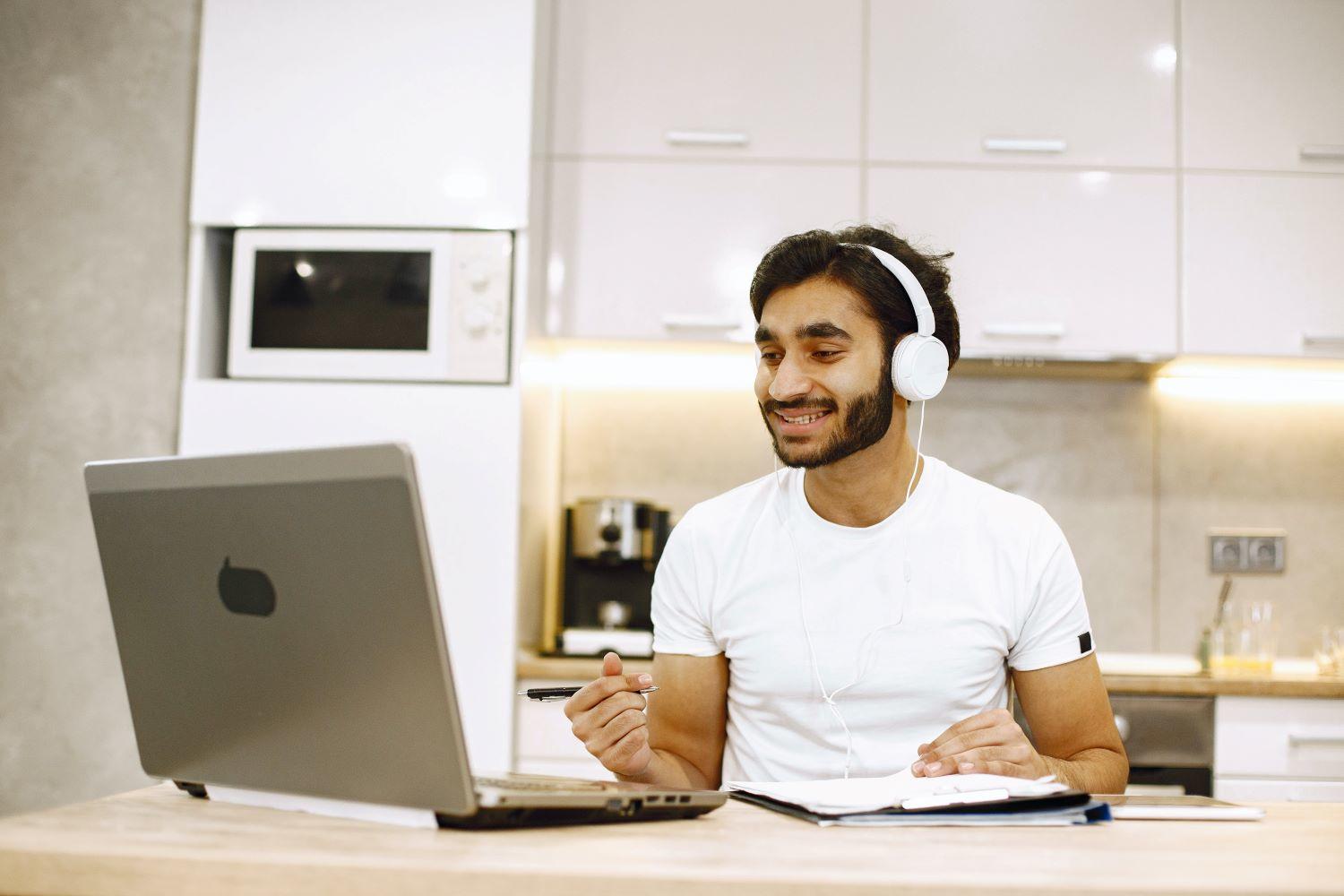 A man smiling with headphones