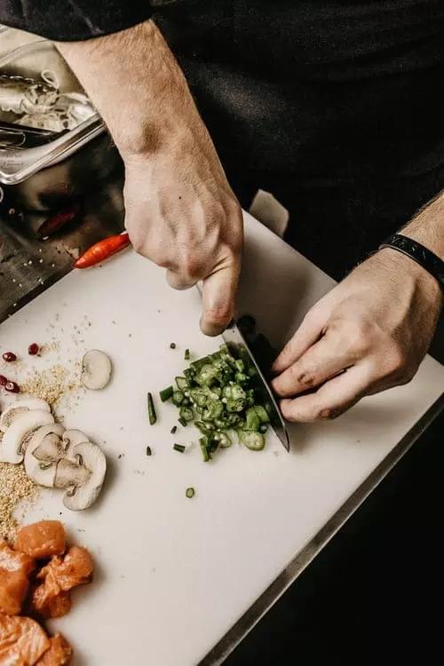 A cook slicing vegetables