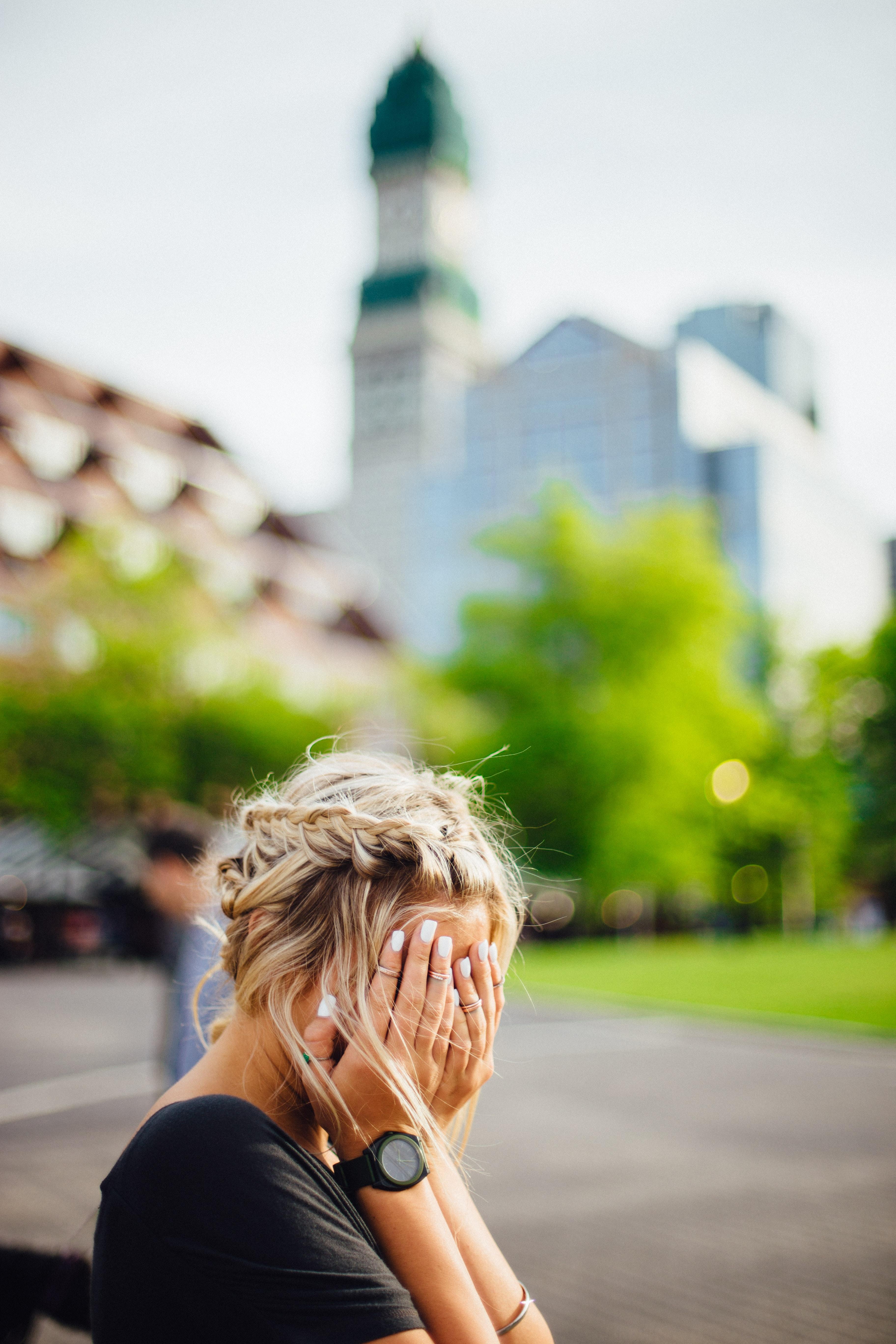 A woman covering her face