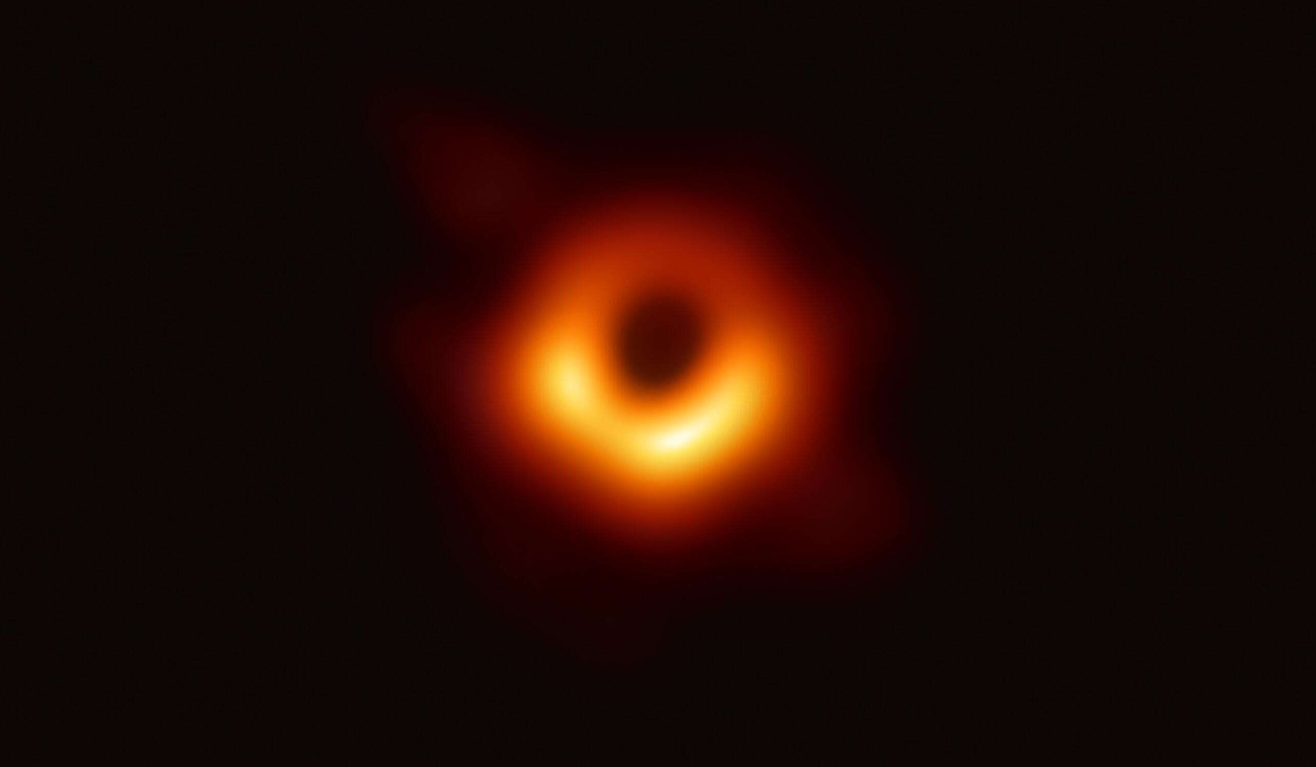 blurry photo of a red and orange ring with black centre and background