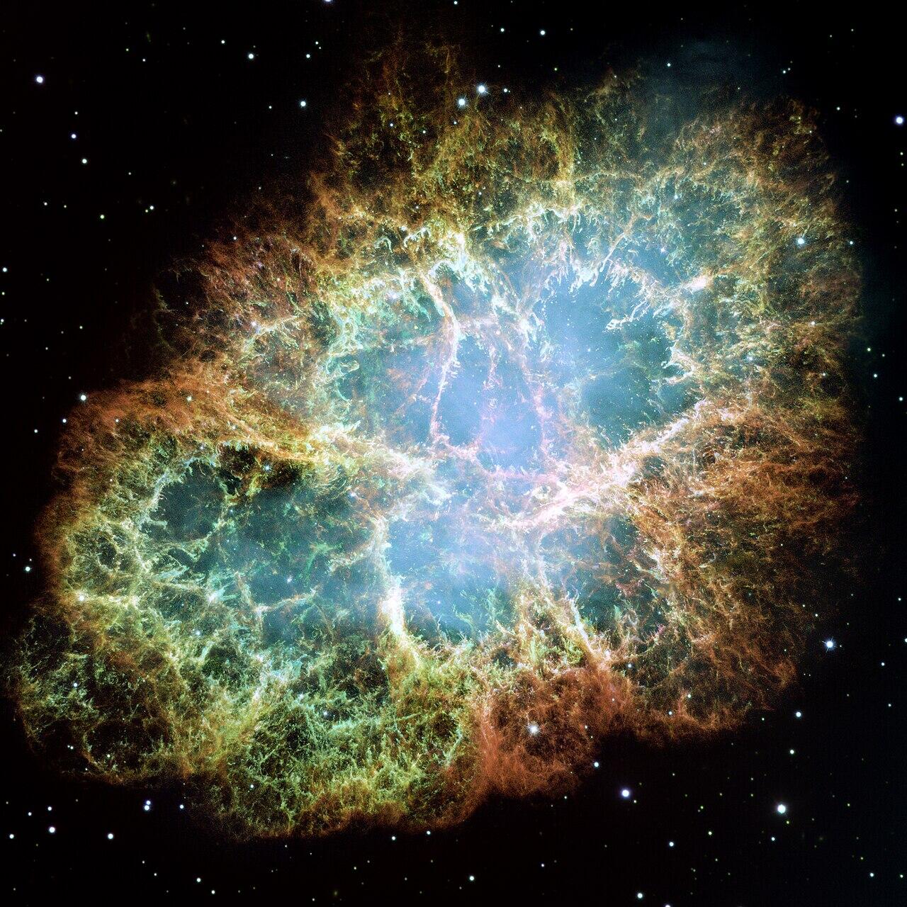 Enhanced photo of the Crab Nebula, a large blue and orange gas cloud in space