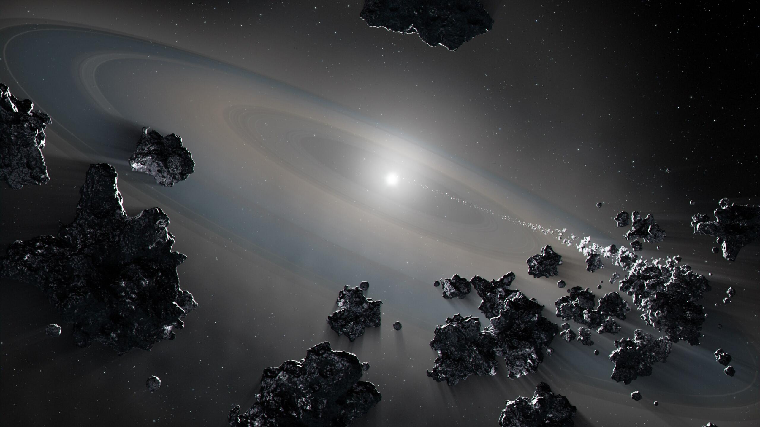 illustration of a bright, white sphere surrounded by thin, transparent white bands of material and chunks of rough material floating in space