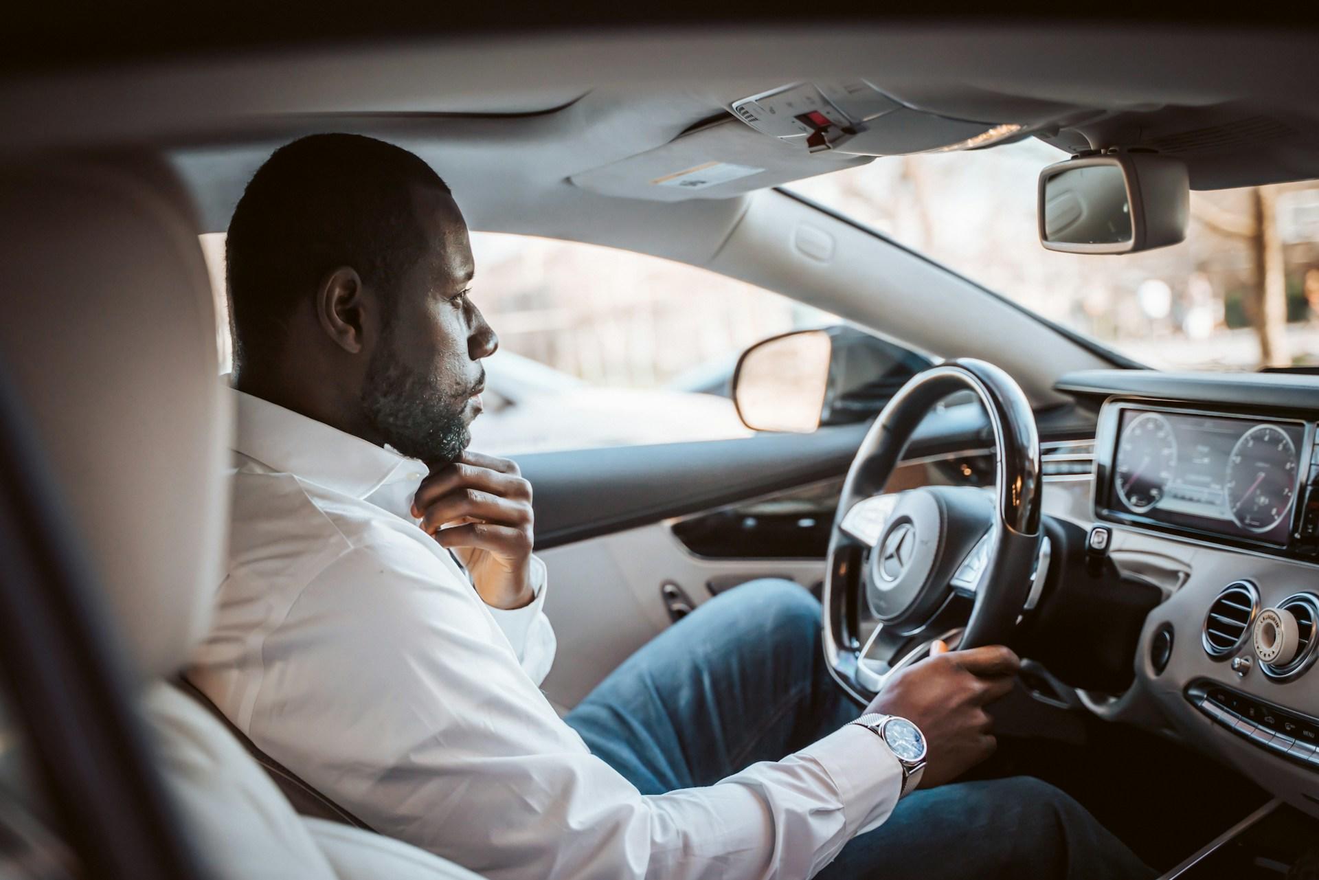 A man driving his car to a tutoring session