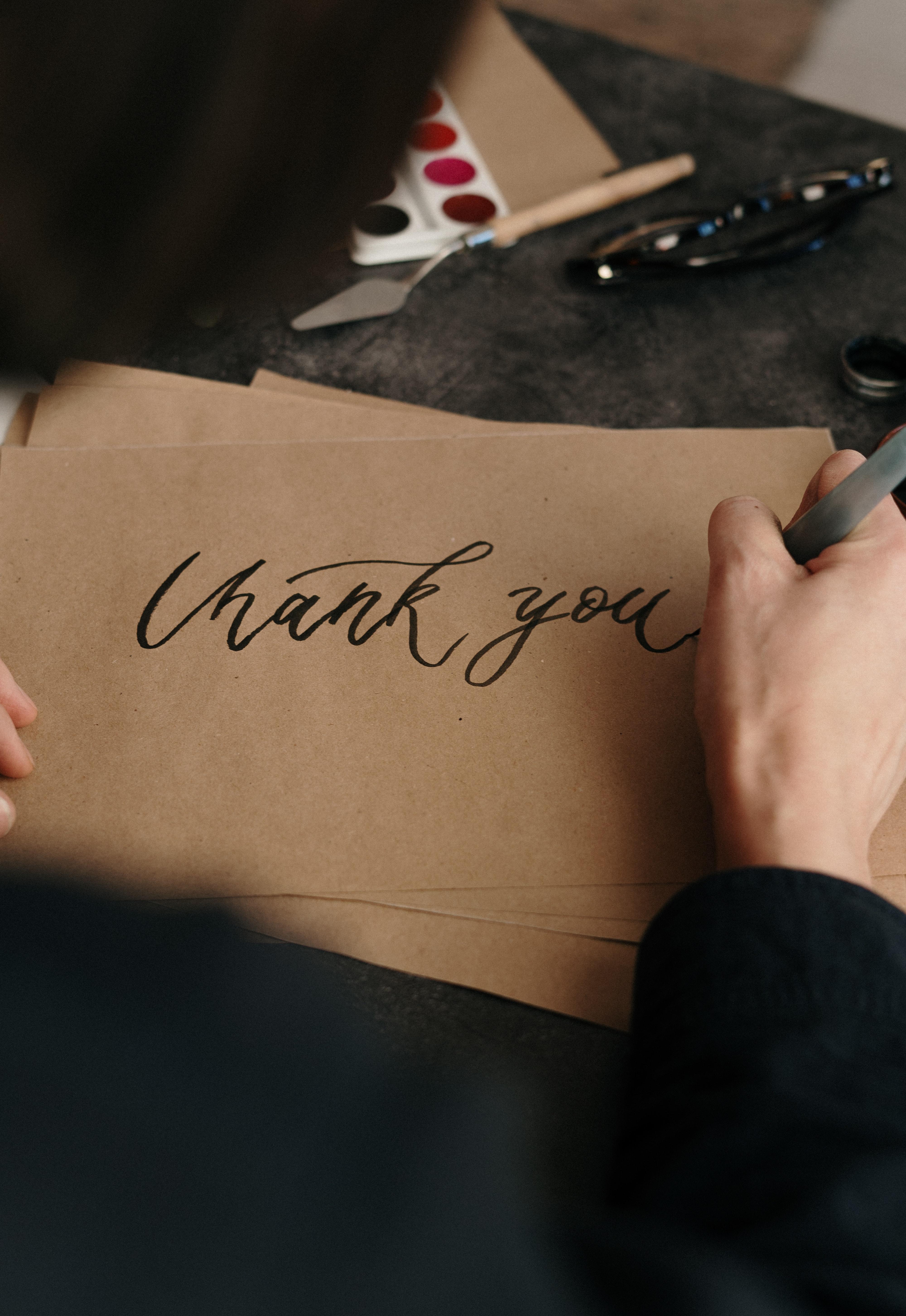A man writing on brown paper