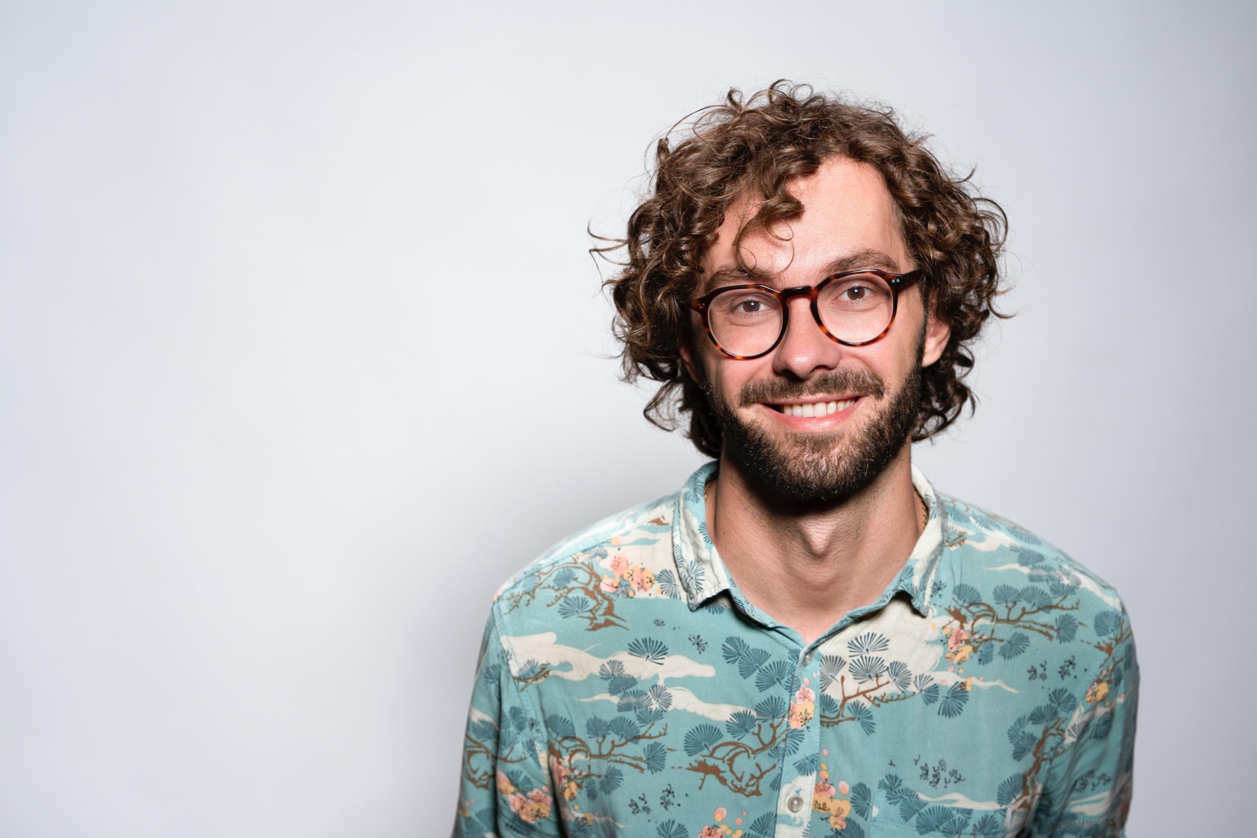 A male teacher smiles at the camera.