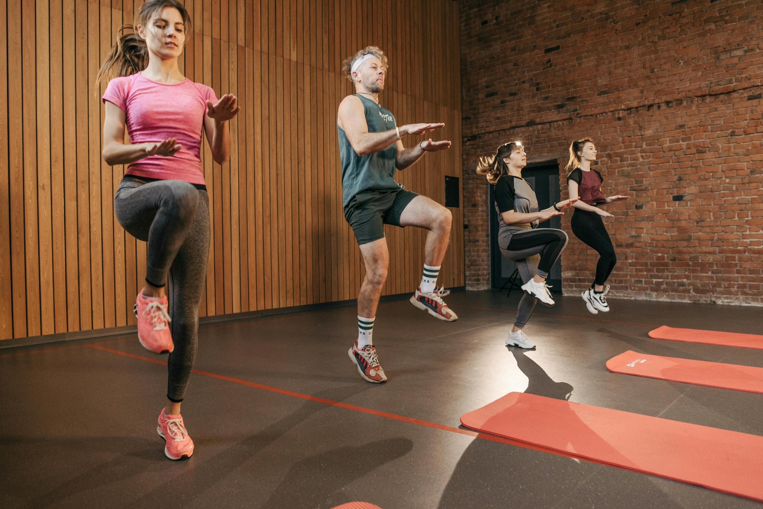 A group fitness class doing high knees together.