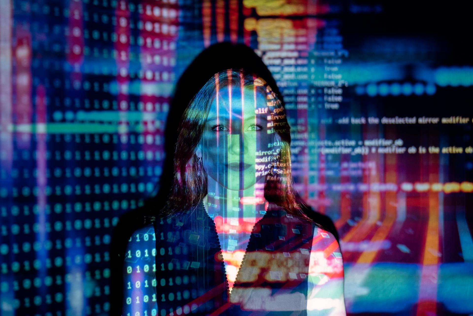 Woman standing in front of a projector projecting codes.
