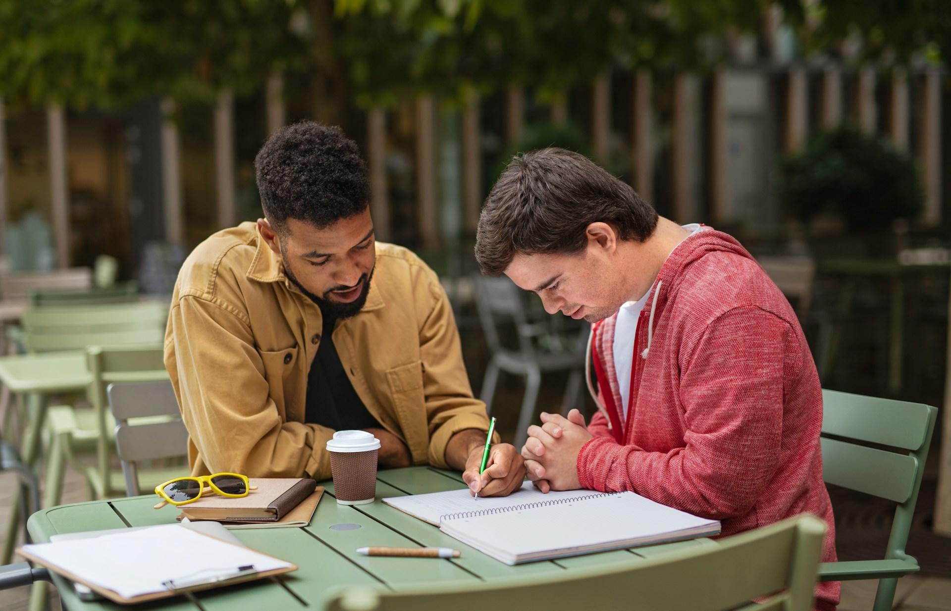 A tutor helping a student with stats in the library. 