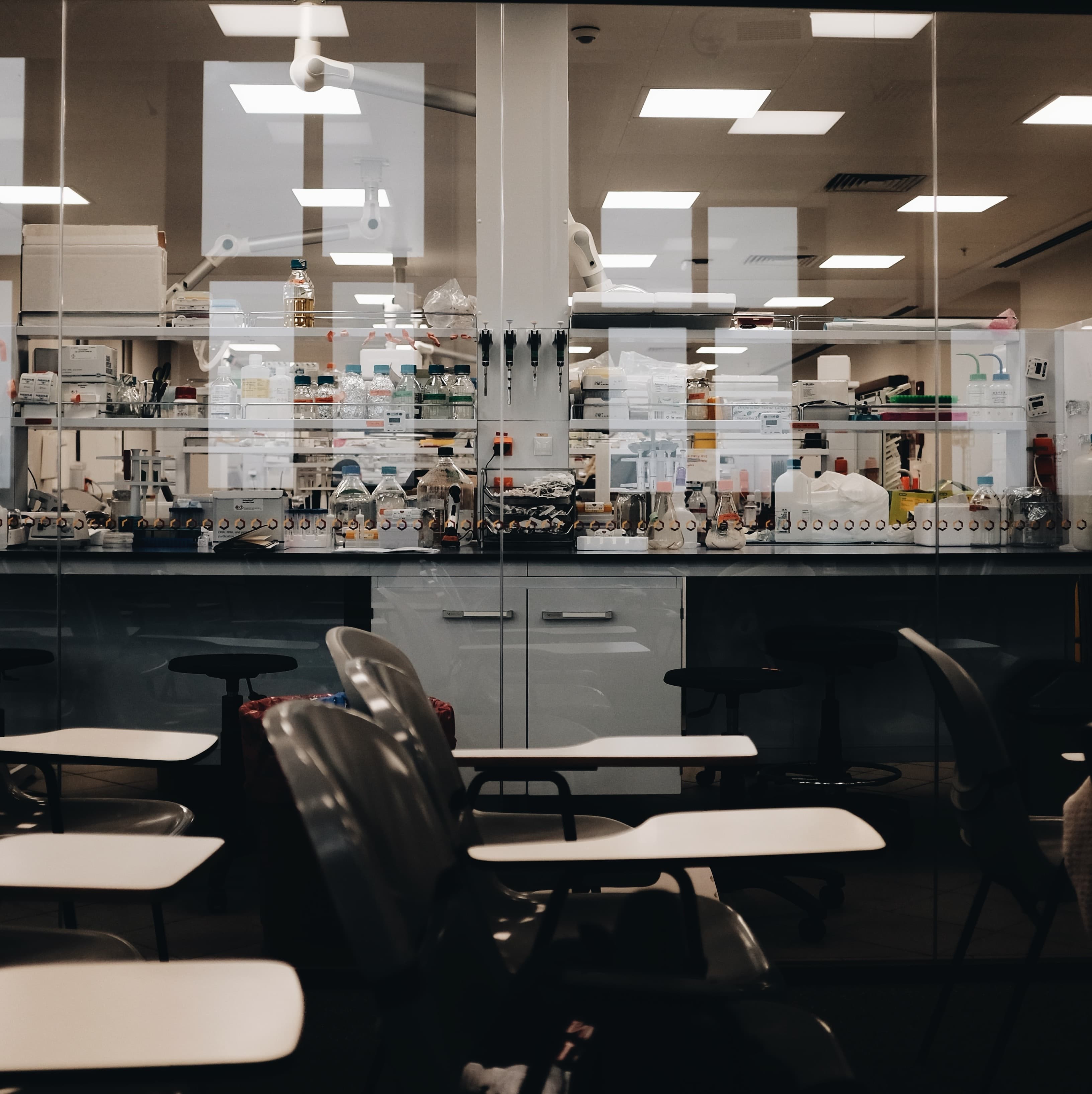 The photograph shows a chemistry laboratory as seen from a study room.