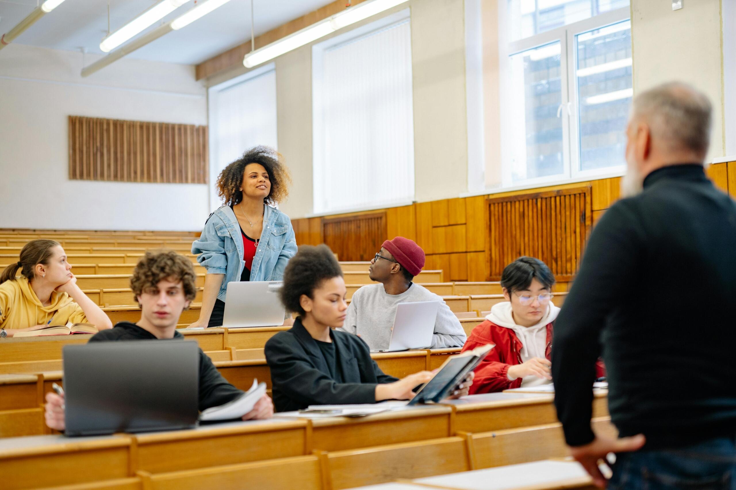 a professor stands in front of students.