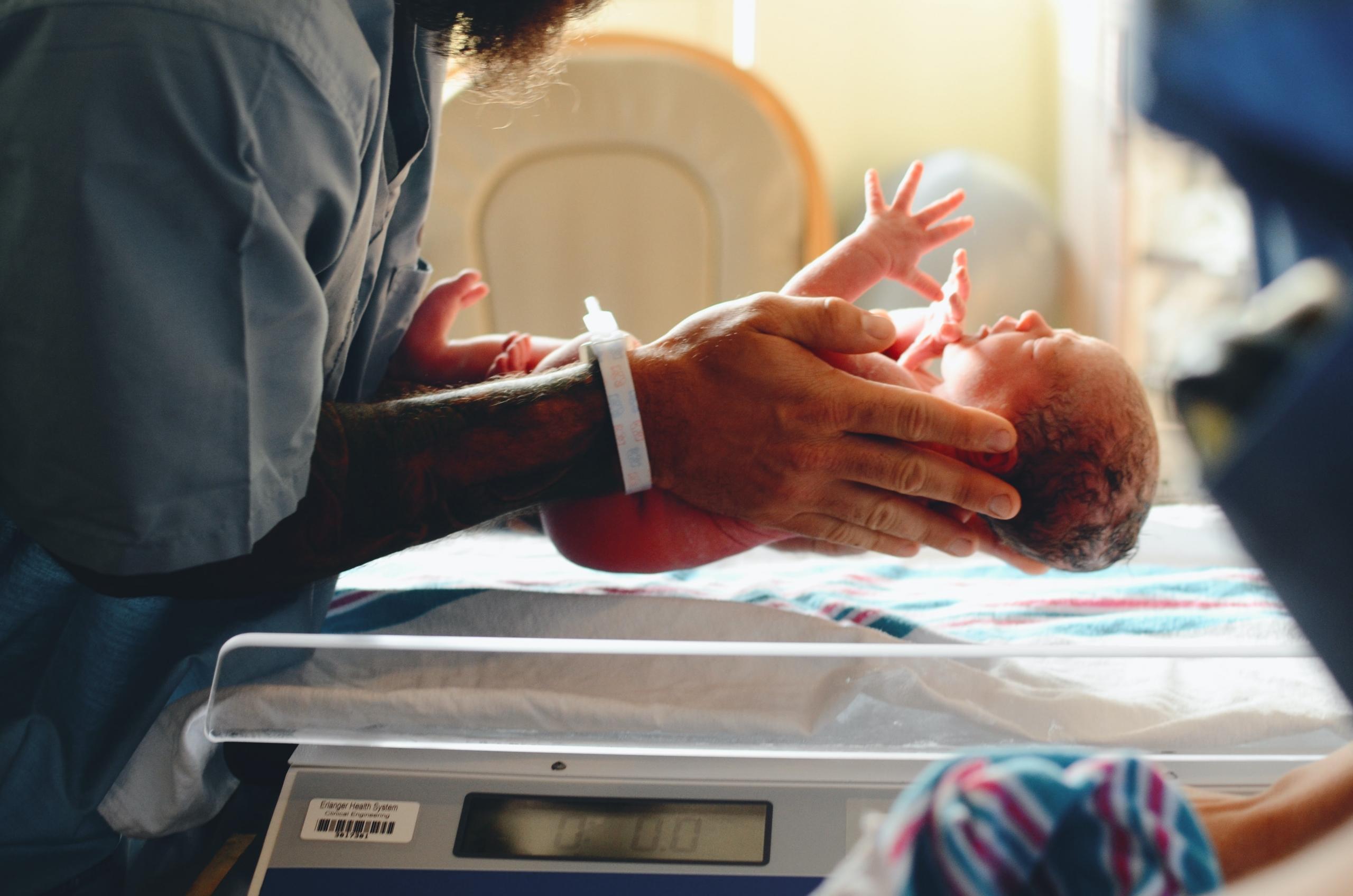 a nurse holds a newborn