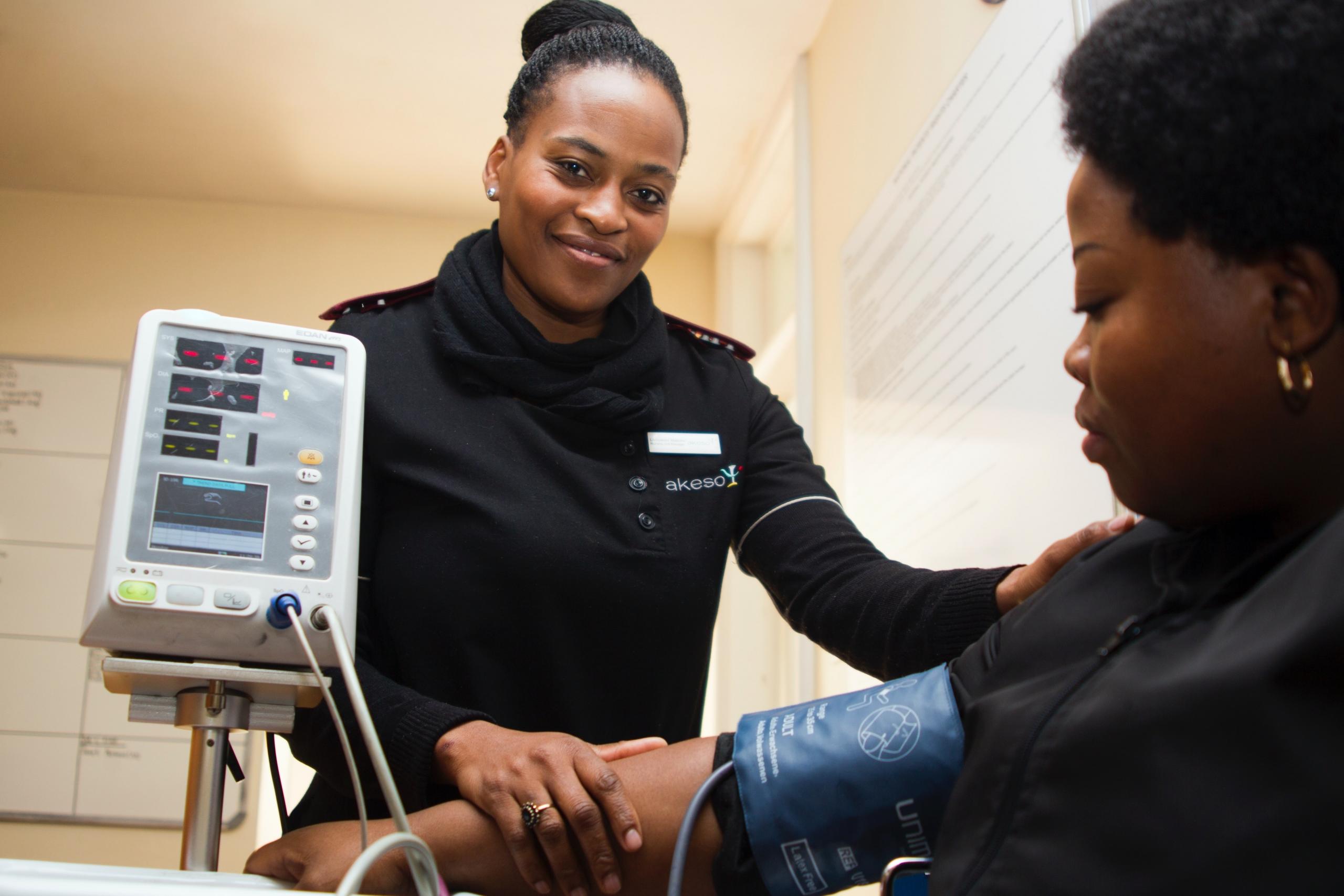 a nurse takes the blood pressure of a patient