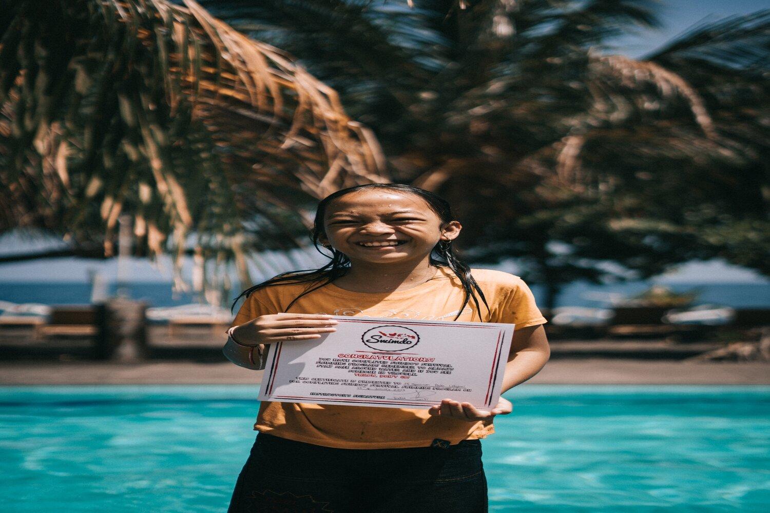 A student holding a certificate