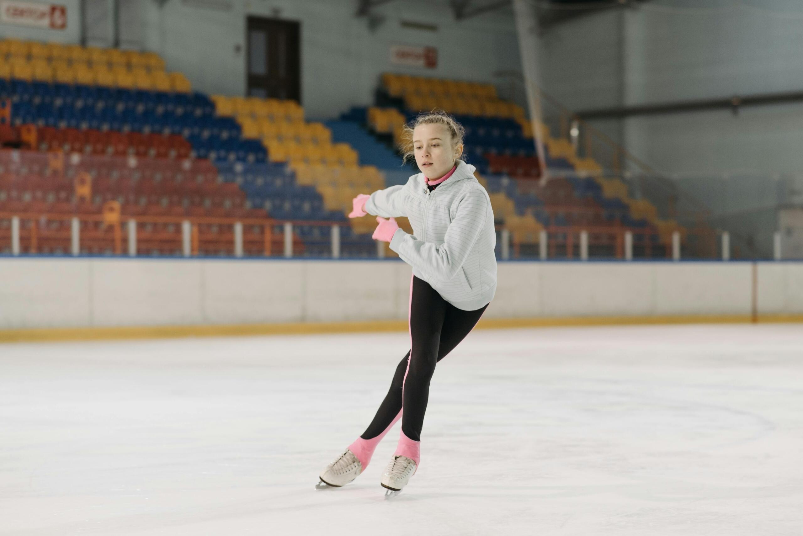 A teenage girl practices figure skating.