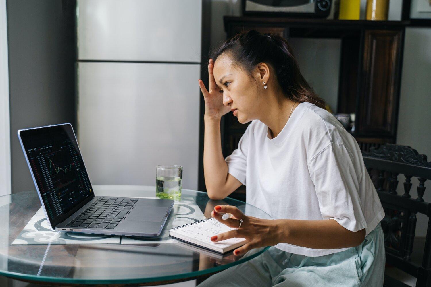 A woman facing a laptop