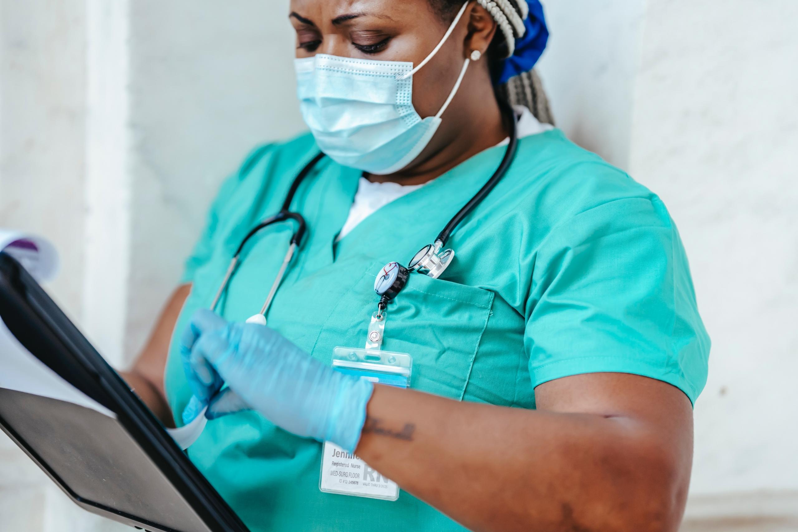 A nurse examines her notes.