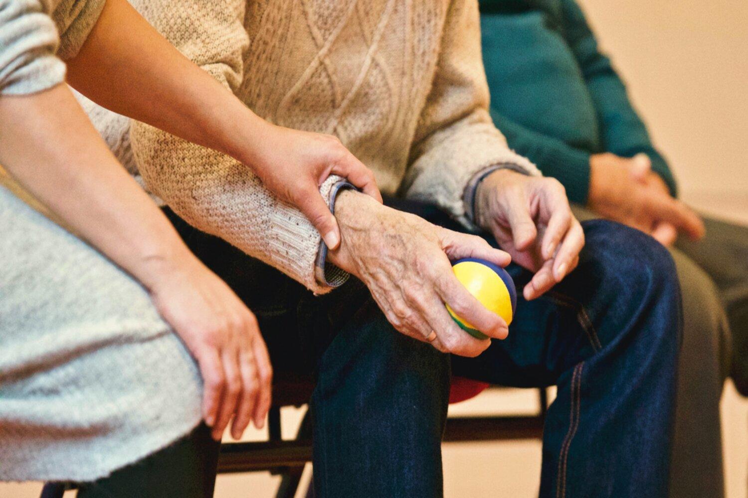A nurse helping an elderly patient