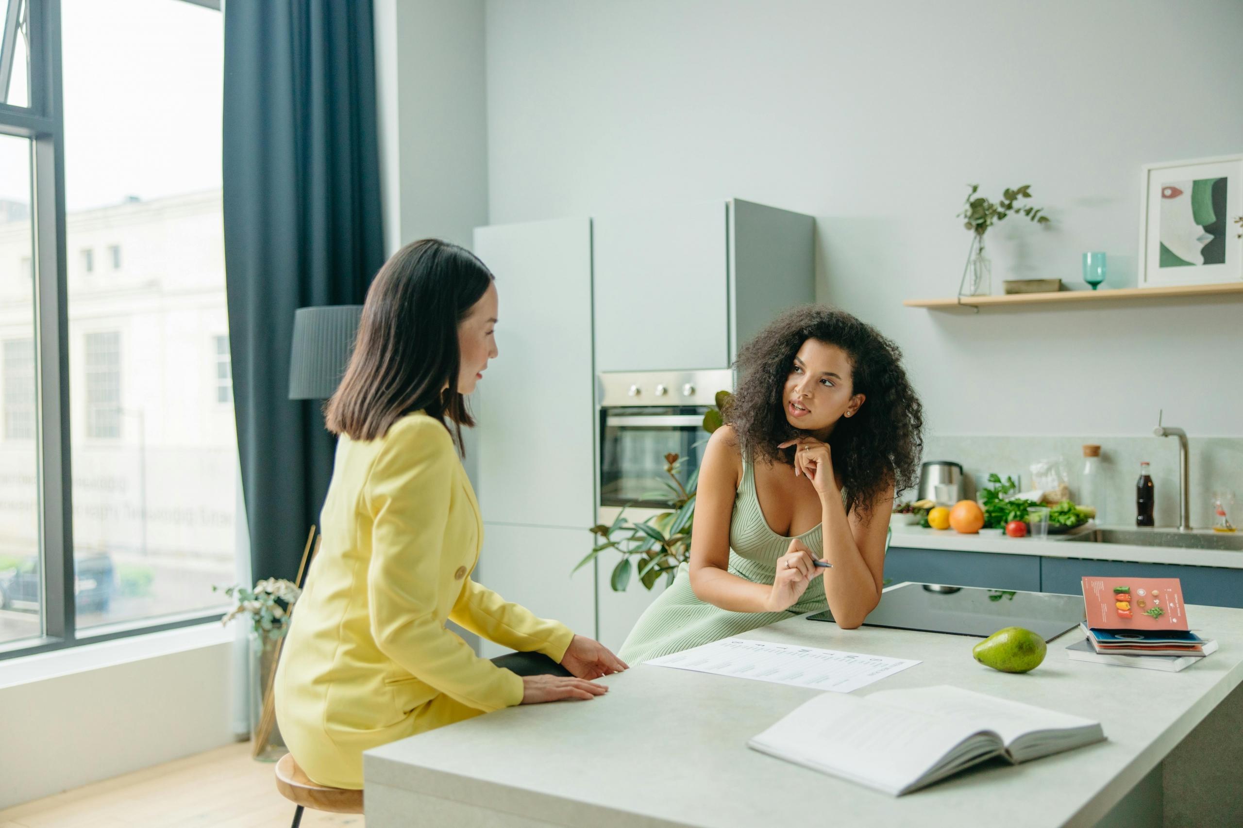 A nutritionist talking with their client in a medical office.
