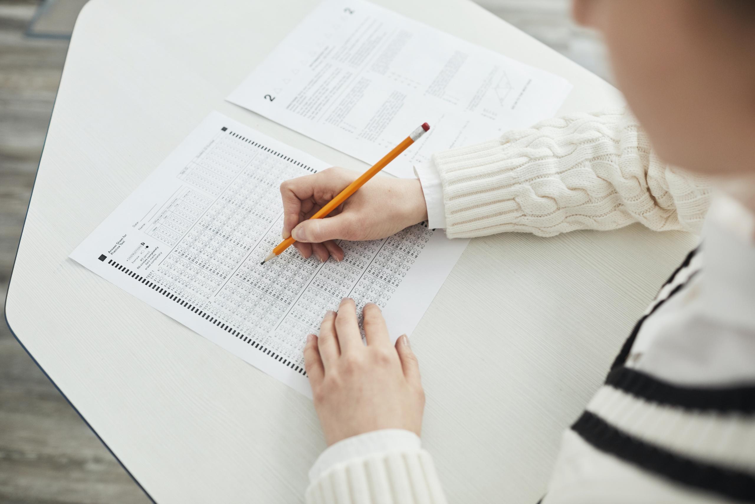 A student fills out a scantron card.