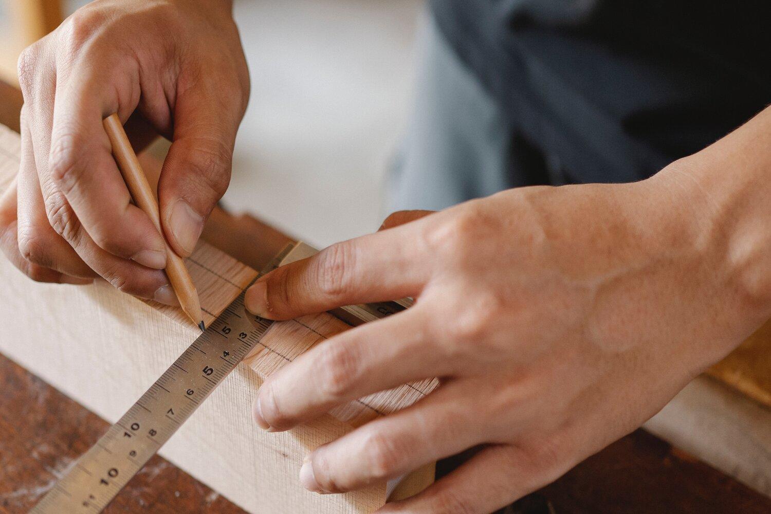 A man working with measuring tape.