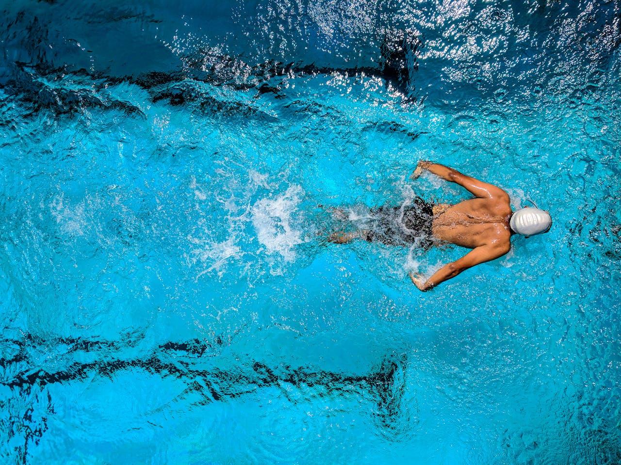 Swimming athlete training in a lane pool.